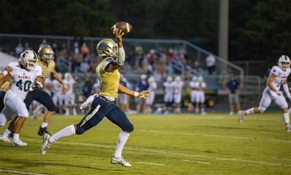 Independence High football player prepares to throw ball